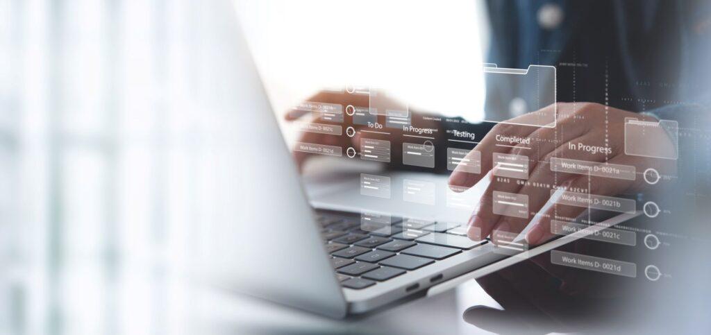 Hands typing on laptop with digital workflow interface overlay – representing structured systems and analytics offered by an onlyfans agency